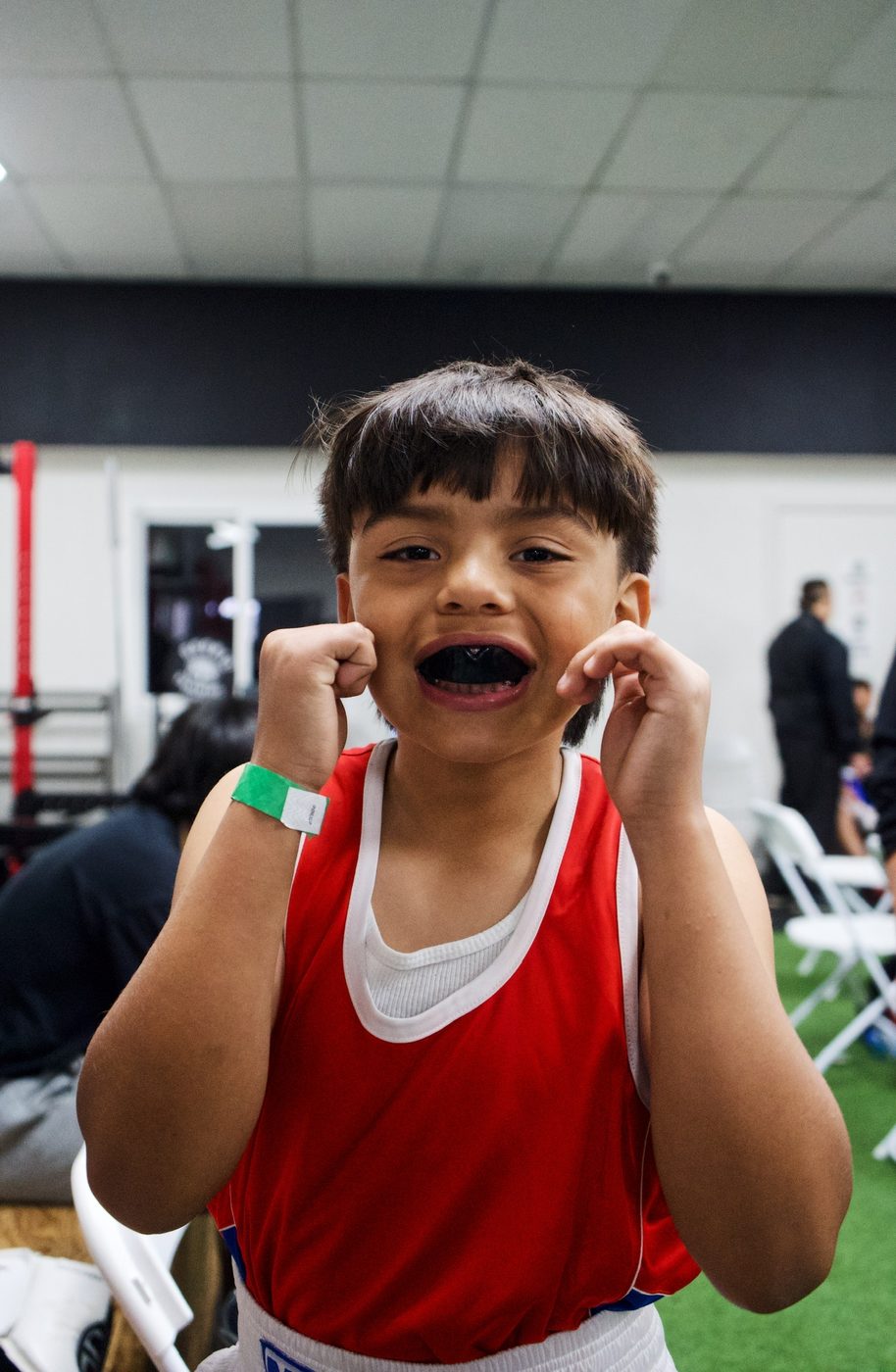 Young boxer with mouthguard before a bout in Oakland