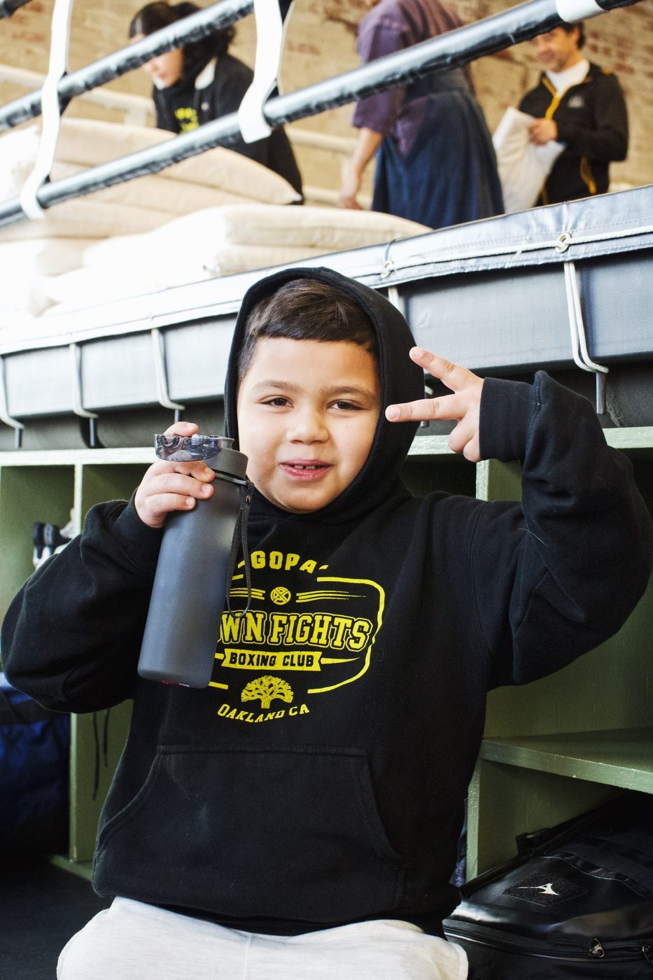 Young boxer in a Gopa Boxing Club hoodie between rounds