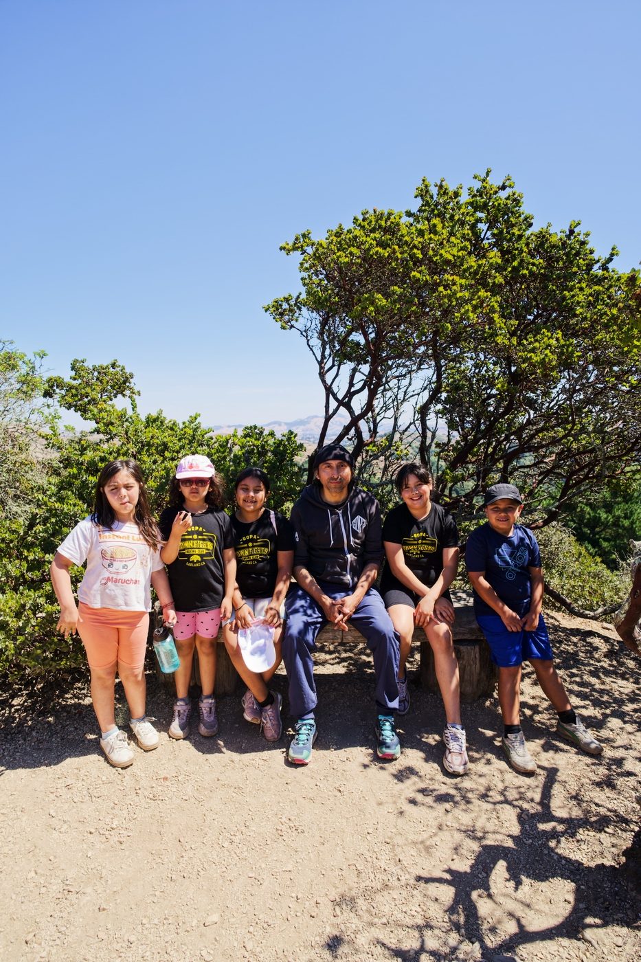 Coach and kids on a group hike in the East Bay hills