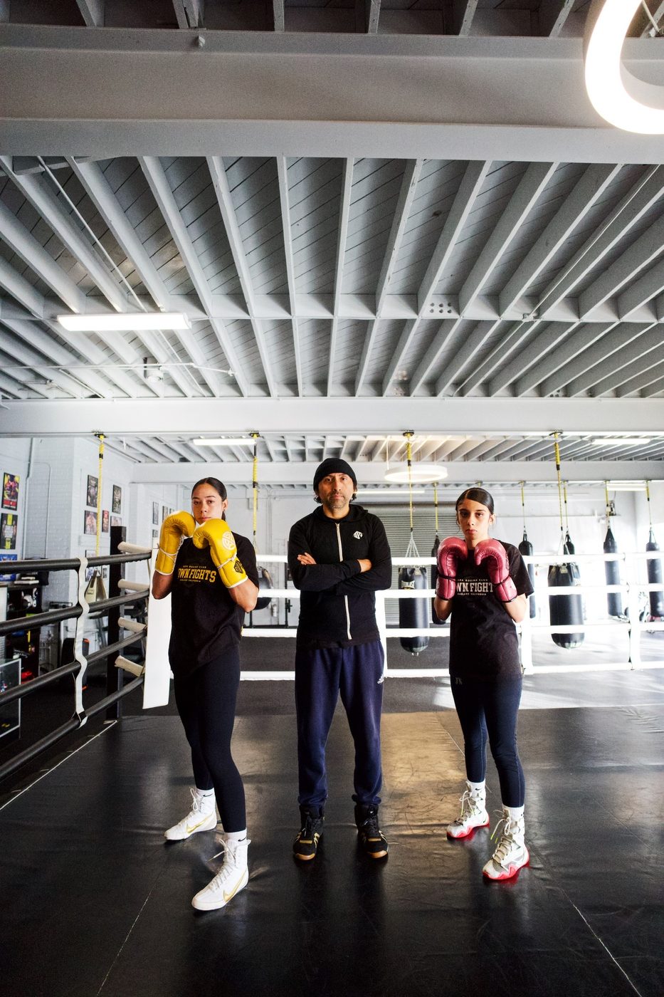 Two young women boxers in the ring with their coach at Gopa Boxing Club