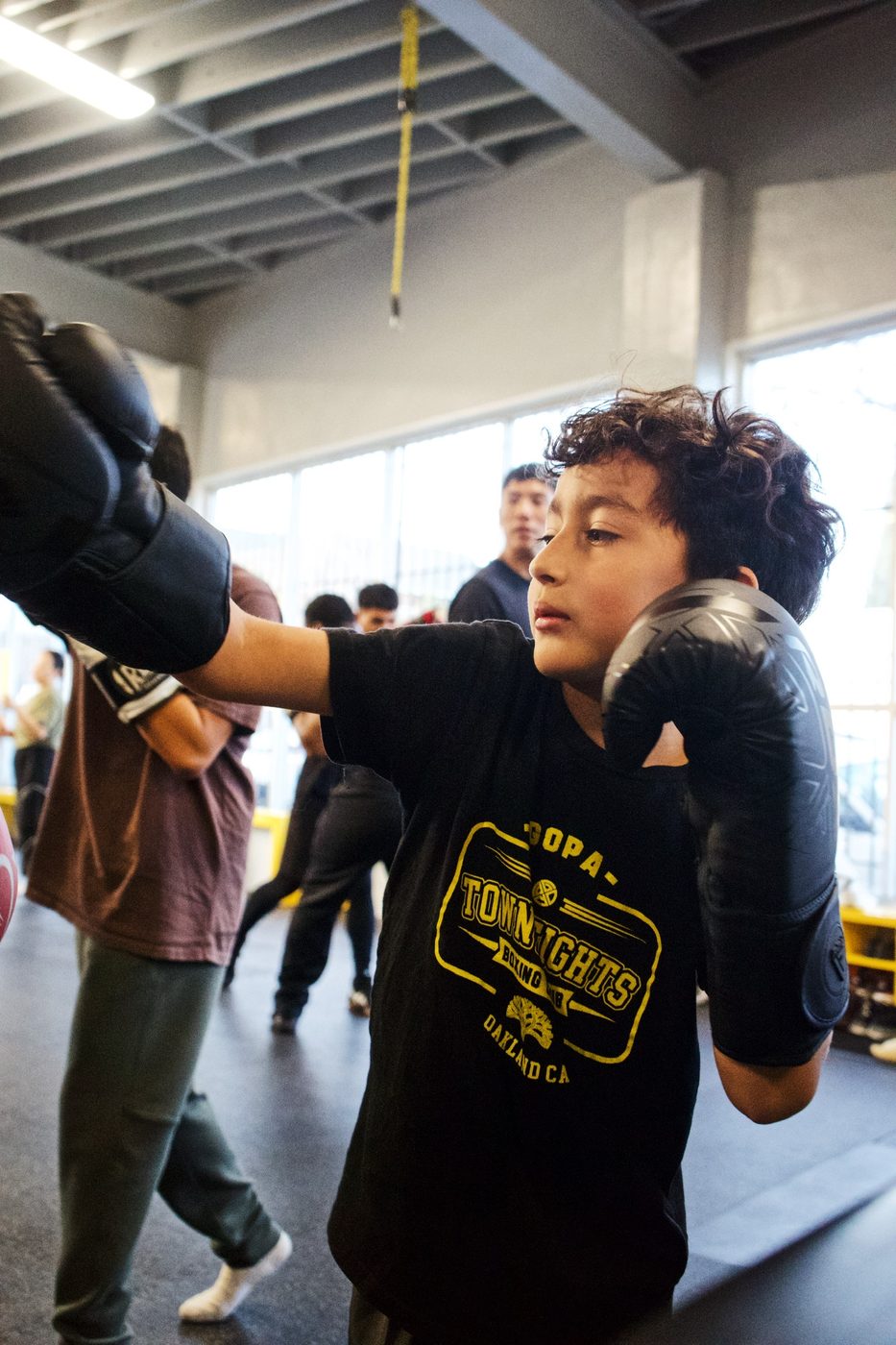 Young boxer working combinations on the mitts at Gopa Boxing Club Oakland