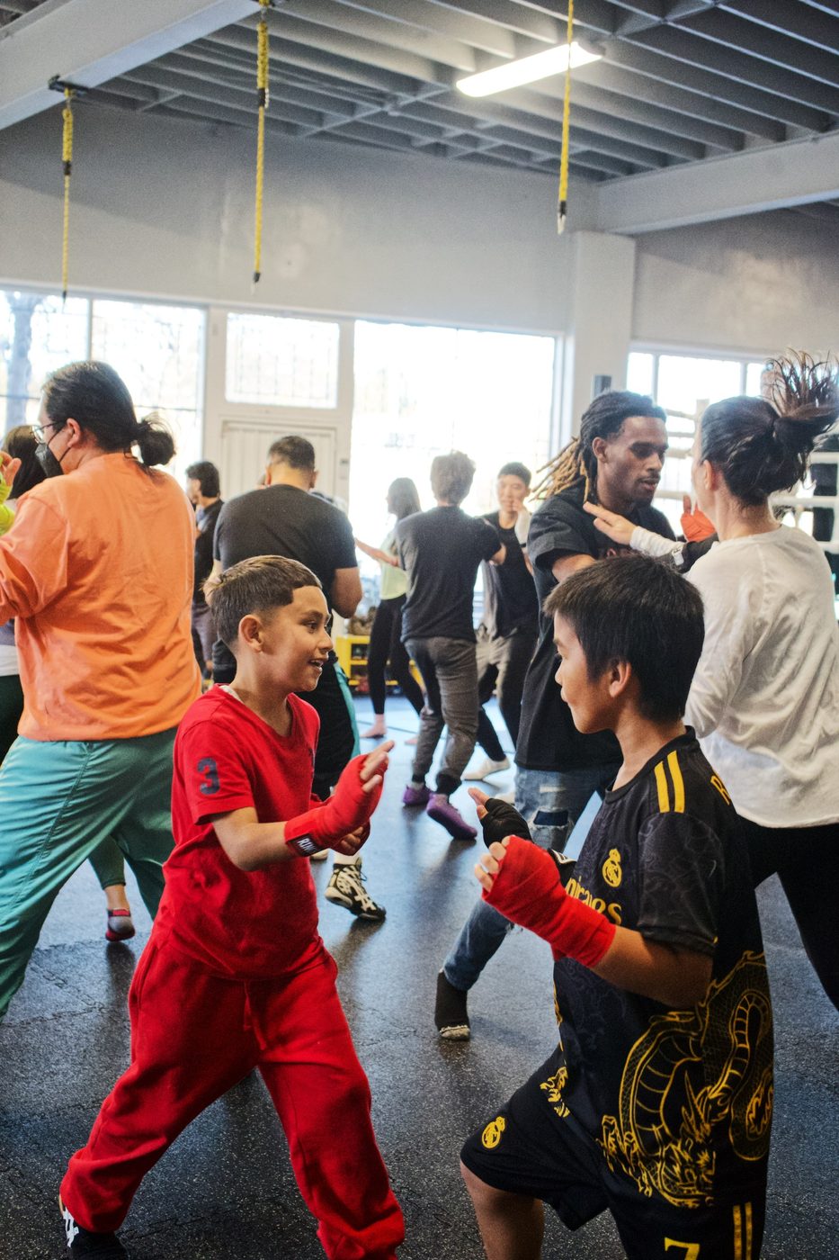 Kids practicing partner drills in a self defense class at Gopa Boxing Club Oakland